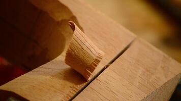 Craftsman with chisel working in wood, close up video