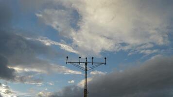 Airplane passing above a lamp posts a cloudy day at sunset video