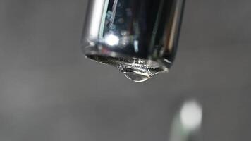 extreme close up dripping water from faucet leaking tap. waste water. drops of water dripping from mixer tap. leaky valve. save water concept budget video