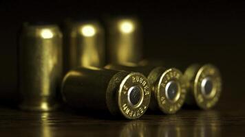 Bullets closeup on black backgrounds. Rubber bullets macro with limited dof on a black background, 9mm full metal jacket. bullet macro with limited dof on a black background photo