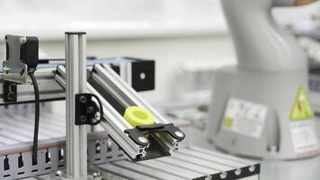 Close up of yellow object created by 3D printer in modern workshop. Scene. Technological background of robotic mechanism making a detail, science concept. photo