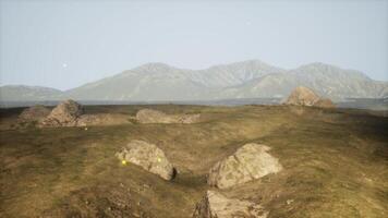 Rocky terrain with mountains in the background under clear sky video