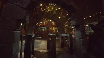 Empty amusement park entrance illuminated by string lights at night video