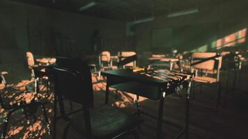 Abandoned school classroom with empty desks and sunlit shadows at dusk video