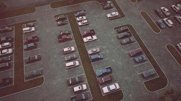 Aerial view of a nearly empty parking lot during late afternoon in autumn video