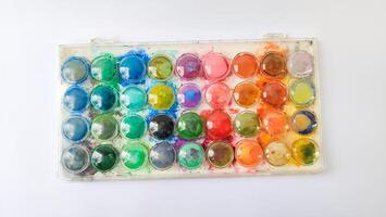 Set with strokes of colorful oil paints on white background, top view photo