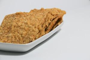 tempe or keripik tempe or kripik tempe. tempeh chips a typical Indonesian food made from soybeans and thinly sliced photo