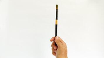 Different brushes with paints on white background photo