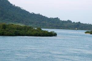 Landscape view between the sky and the vast sea, located at Sunda Strait, Lampung, Indonesia photo