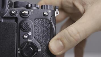 RUSSIA, MOSCOW-DECEMBER, 2020. Memory card in camera. Action. Close-up photographer inserts new memory card into camera. Replacing memory card in camera photo