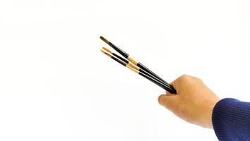 Different brushes with paints on white background photo