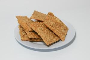 tempe or keripik tempe or kripik tempe. tempeh chips a typical Indonesian food made from soybeans and thinly sliced photo