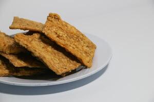 tempe or keripik tempe or kripik tempe. tempeh chips a typical Indonesian food made from soybeans and thinly sliced photo