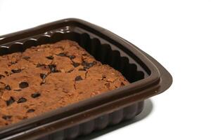 Brownies are a popular processed chocolate cake, decorated with chocolate chip toppings, nuts, almonds or biscuits. photo