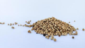 Aromatic spices. Pile of different peppers isolated on white photo