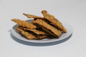 tempe or keripik tempe or kripik tempe. tempeh chips a typical Indonesian food made from soybeans and thinly sliced photo