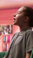 Young girl getting angry at psychologist when reviewing disturbing drawings, showing signs of murder deviant behavior. Teenager with social problems and anger management issues. Camera A. video