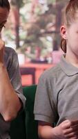 Expert shows disturbing gory drawings to mother of a disconnected girl who struggles to focus, depersonalization concept. Adolescent with derealization and dissociation issues. Camera A. video