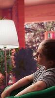 Psychotherapist focusing on a teenager with personal struggles and hormonal shifts in therapy session. Expert listening attentively, providing support for mental and social issues. Camera B. video