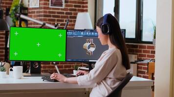 Software developer works in a modern office with green screen and dual monitors. Home workspace emphasizes industrial innovation and expertise in manufacturing design. Camera B. video