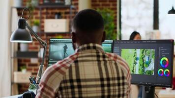 Male creator edits a multimedia project at a modern office, using professional tech tools and editing software to manage timeline editing and production. Work from home. Camera B. video
