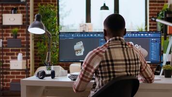 Engineer designs a turbine in an industrial office using CAD software. Working from home with dual monitors and tools for 3D rendering, boosting productivity and technical precision. Camera B. video