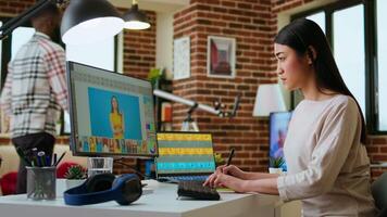 Asian creative woman edits photos using professional design software in a modern home office. Working with digital tools in the graphic design industry, retouching techniques. Camera A. video