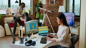 Creative woman manages photo editing and design projects on her computer in a tech driven workspace, using digital tools to enhance productivity in the graphic design industry. Camera A. video