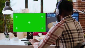 Male freelance designer works remotely on 3D prototypes using green screen and CAD software. Home workspace highlights the balance between productivity and comfort in industrial design. Camera B. video