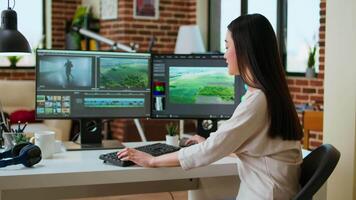 Female filmmaker working on post production from home office, editing timelines and color grading for a shoot. Tech driven workspace showcases a digital workflow for production. Camera A. video
