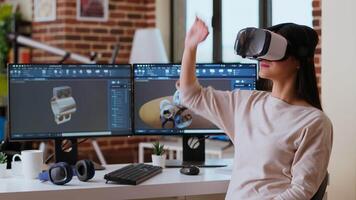 Asian woman engineer creating prototypes with vr glasses and 3D modeling software, working from home to develop new manufacturing gears and turbines. 3D design tech tools. Camera B. video
