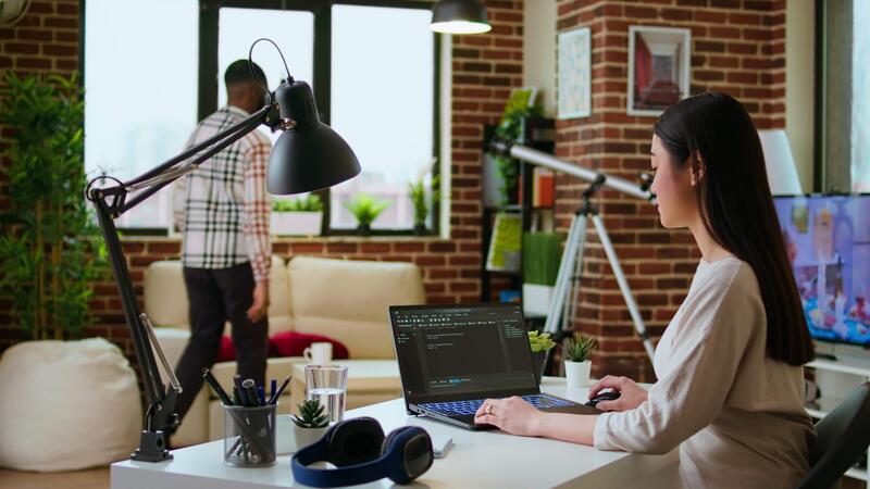 Professional asian software engineer is working remotely typing code on ...