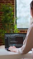 Vertical Professional asian software engineer is working remotely typing code on a laptop, using programming language. Woman works on cloud computing, software projects in a digital environment. Camera B. video