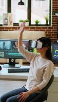 Vertical Asian modern editor using virtual reality glasses and mixing clips, using interactive gadget vr headset to edit and do color grading for a montage. editing software. Camera A. video