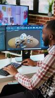 Vertical African american designer uses 3D modeling tools and CAD software for industrial projects. Working on creating prototypes and gears models for the manufacturing industry. Camera A. video