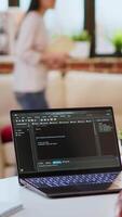 Vertical Male programmer developing an app on his laptop and working remotely. Home office setup includes digital tools and focuses on software engineering and coding, IT specialist. Camera B. video