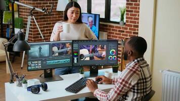 Creative team interracial partners collaborating on a editing project, using high end production software for color grading and mixing. Diverse couple uniting forces for work. Camera A. video