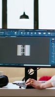Vertical Expert engineer develops industrial prototypes using 3D modeling software at her home office, featuring dual monitors and modern office equipment perfect for innovative design processes. Camera B. video