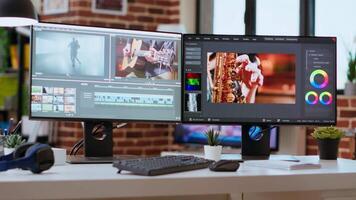 Media creation studio were specialists can work on editing footage for a cinematic project. Desk in living room includes advanced editing tools and tech equipment for post production. video