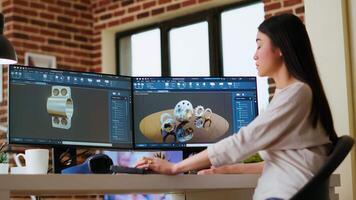 Asian professional engineer works on coding industrial designs using advanced software tools. Living room office includes dual monitors and technical equipment for high productivity. Camera B. video