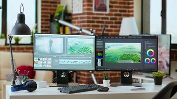 Creative workspace desk for production in living room, equipped with the latest technology and editing software for film editing and media creation, tools of freelance editor. video