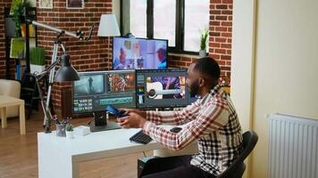 African american filmmaker man works on a professional shoot, managing the editing timeline of a project. Employing modern editing tools and color grading software. Camera A. video