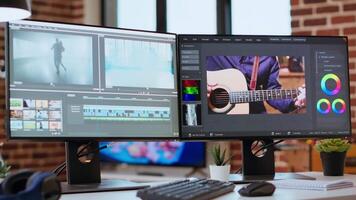 Empty editing tools and a color wheel running on pc at desk, timeline editing, color grading and media creation for a shoot. Post production software on dual monitors. video