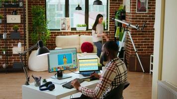 Freelance graphic designer editing photos on a modern computer setup in a remote office. Ideal workspace for a digital design professional, retouching digital pictures from home. Camera A. video
