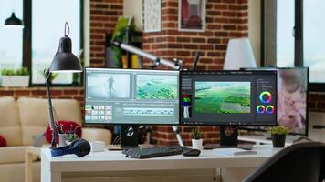 Modern digital workspace in the living room focused on tech and productivity, dual monitors displaying post production tools for creation. Clean desk setup supports efficient production. video