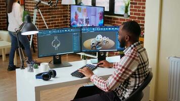 African american designer uses 3D modeling tools and CAD software for industrial projects. Working on creating prototypes and gears models for the manufacturing industry. Camera A. video