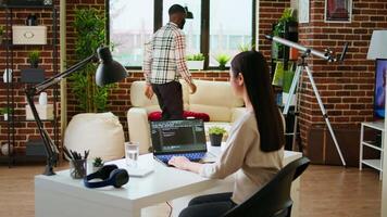 Asian freelancer woman works on programming code in a modern office at home, using her laptop for computer science. IT specialist supports coding, web development and digital innovation. Camera A. video