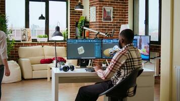 Engineer designs a turbine in an industrial office using CAD software. Working from home with dual monitors and tools for 3D rendering, boosting productivity and technical precision. Camera A. video