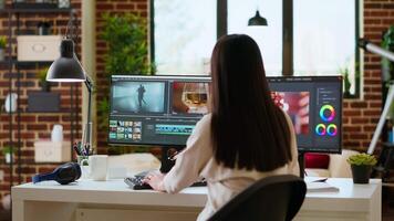 Female editor focuses on color grading while working on a film project in a professional creative studio. Professional woman uses advanced tech tools for editing. Camera B. video