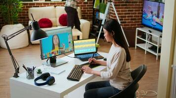 Freelance designer works on a photo editing project in a remote office, using advanced design software. Home workspace promotes creativity and innovation for online work. Camera A. video
